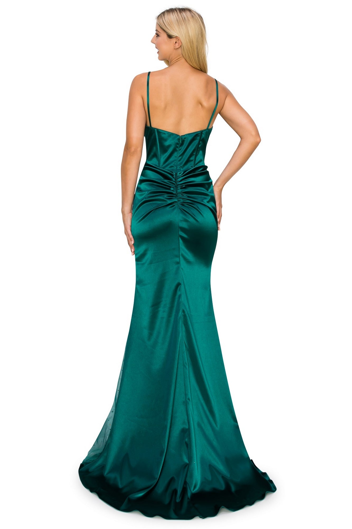 A woman stands facing away, wearing the Sheer Side-Slit Long Corset Prom Dress 8037J in emerald green satin, featuring thin straps and a ruched back.